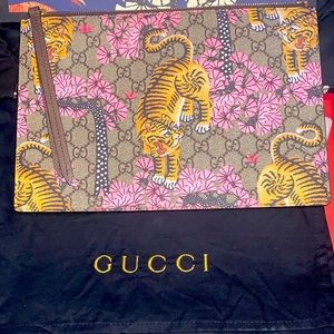 Gently used Tiger pattern Gucci clutch.